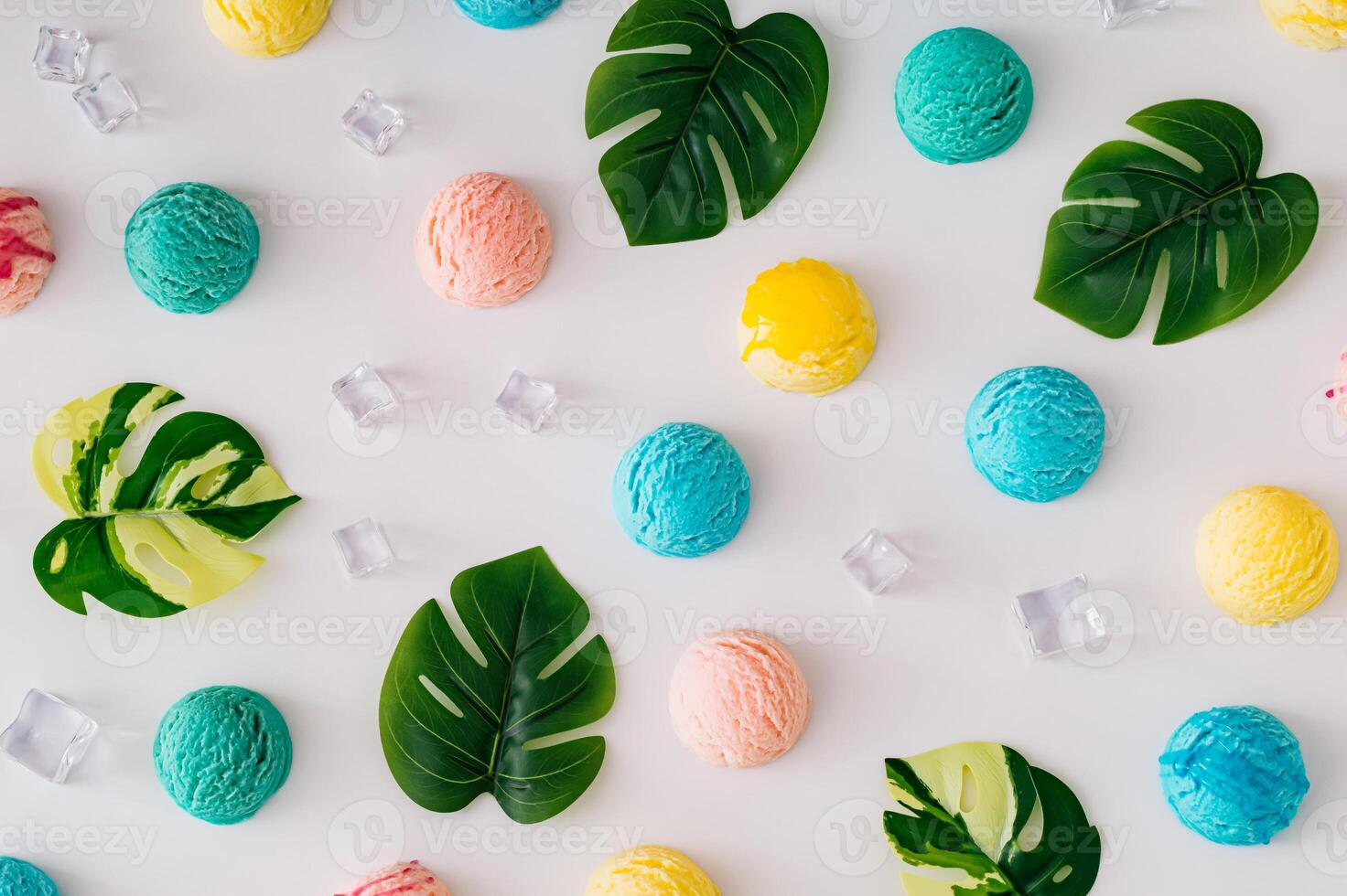 Playful and vibrant summer pattern featuring delicious ice cream scoops, tropical leaves and ice cubes on white background. A fresh and fun design that captures the essense of sunny days. Flat lay. photo