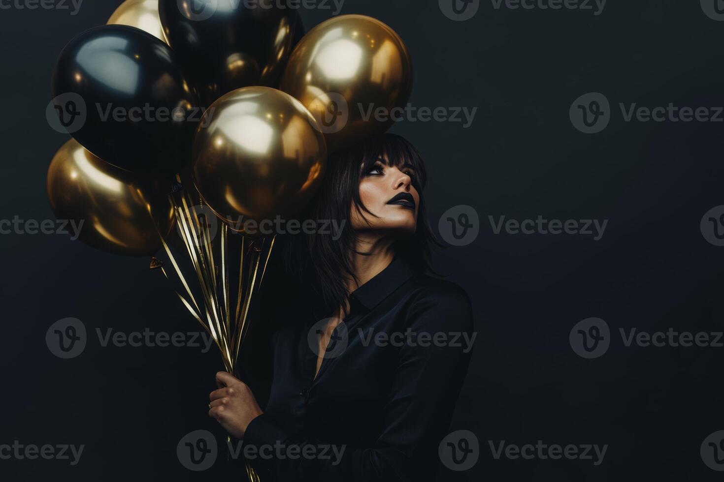 Stylish woman in black attire holds black and gold balloons against a dark backdrop for Black Friday promotions photo