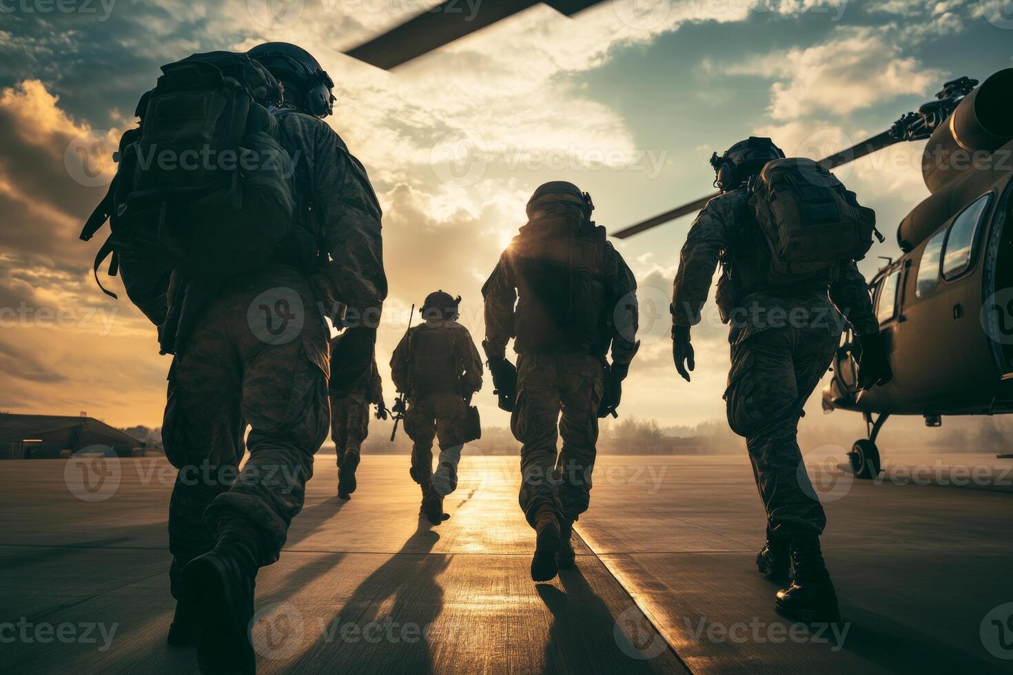 Military personnel disembark from a helicopter at sunset for deployment in a tactical operation photo