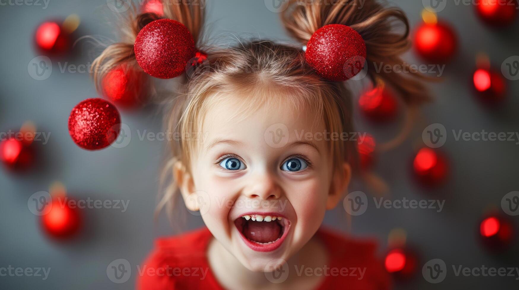 A joyful child with playful expressions and red ornamented pigtails brings cheer during a festive season photo