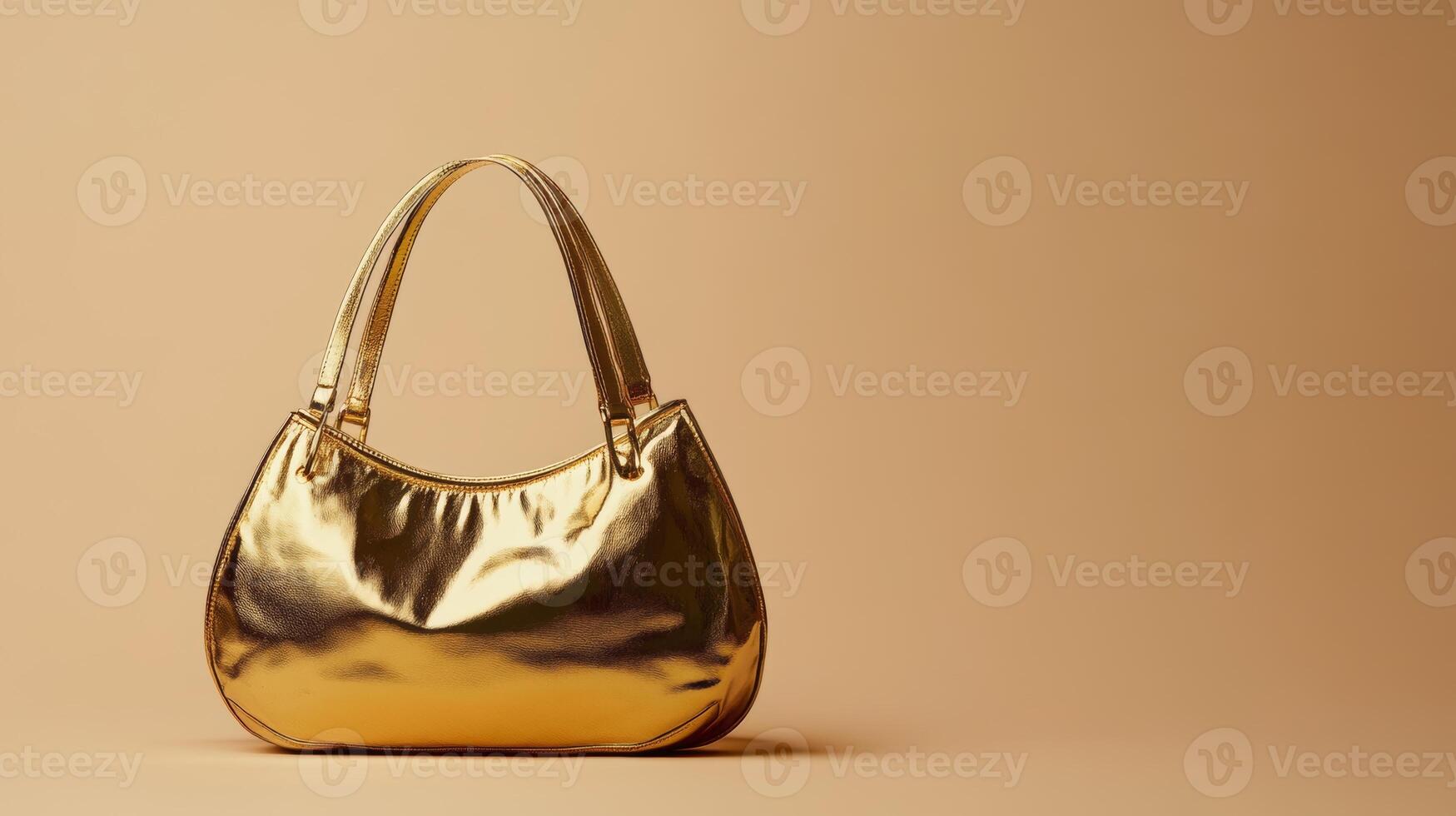 Luxurious shiny gold handbag showcased against a minimalist beige background emphasizing fashion and elegance photo
