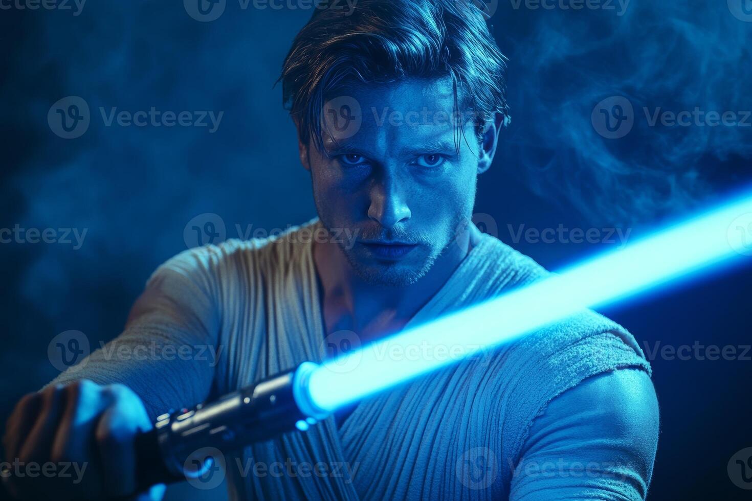 A man confidently wielding a bright blue lightsaber in a dynamic pose, showcasing creativity and strength in a dramatic setting photo