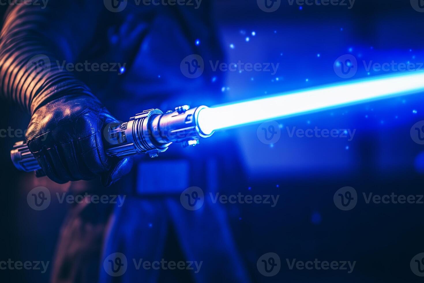 A man grips a bright blue lightsaber, showcasing power and creativity in a dynamic action pose in a dimly lit environment photo