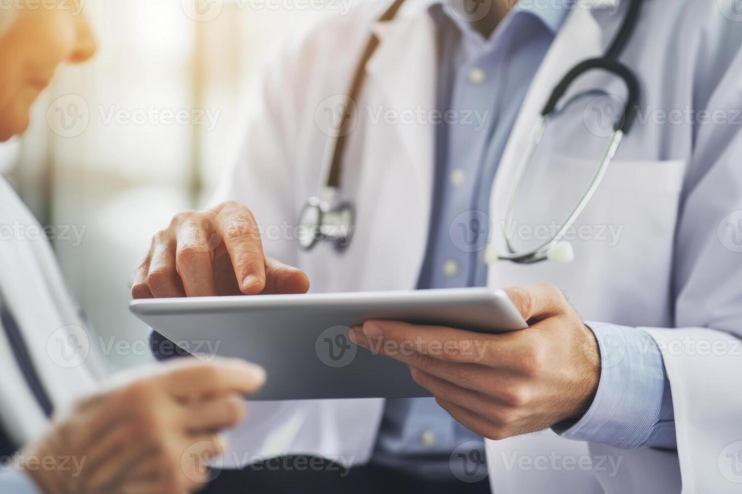 Young doctor consults with older patient using a digital tablet in a modern healthcare setting during a routine check-up photo