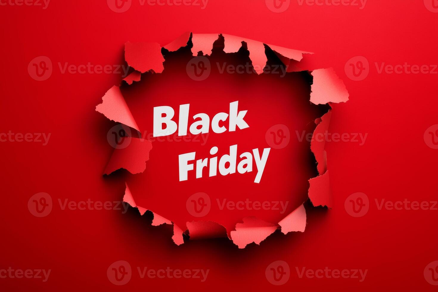 Exciting Black Friday sale announcement with a torn paper effect on a vibrant red background to attract shoppers in November photo