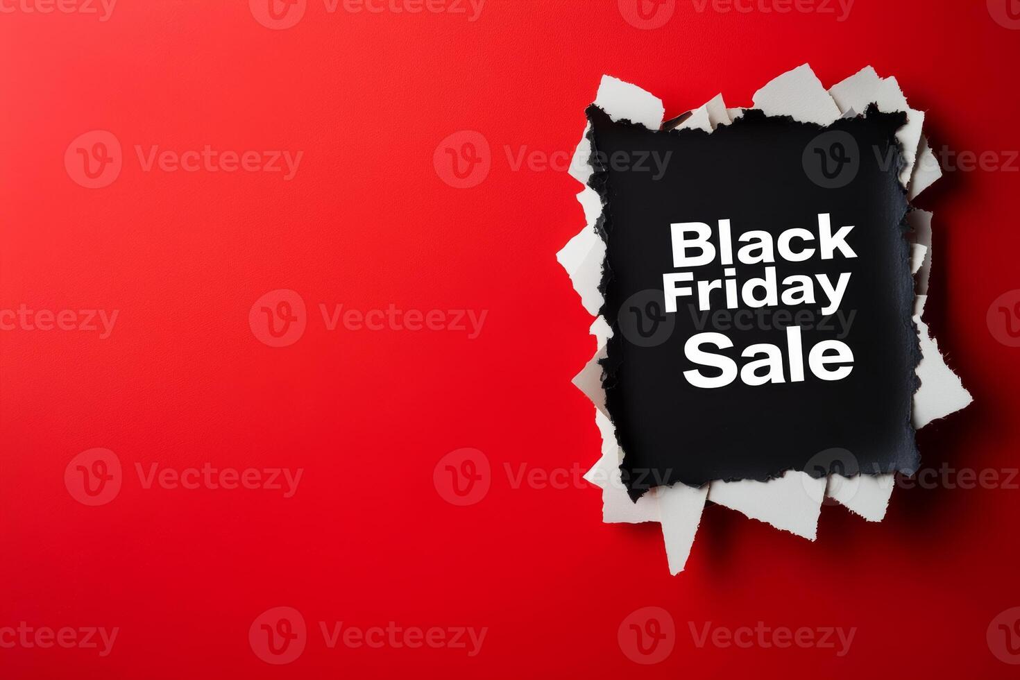 Announcing the Black Friday sale with a torn paper effect on a vibrant red background for an exciting shopping experience photo
