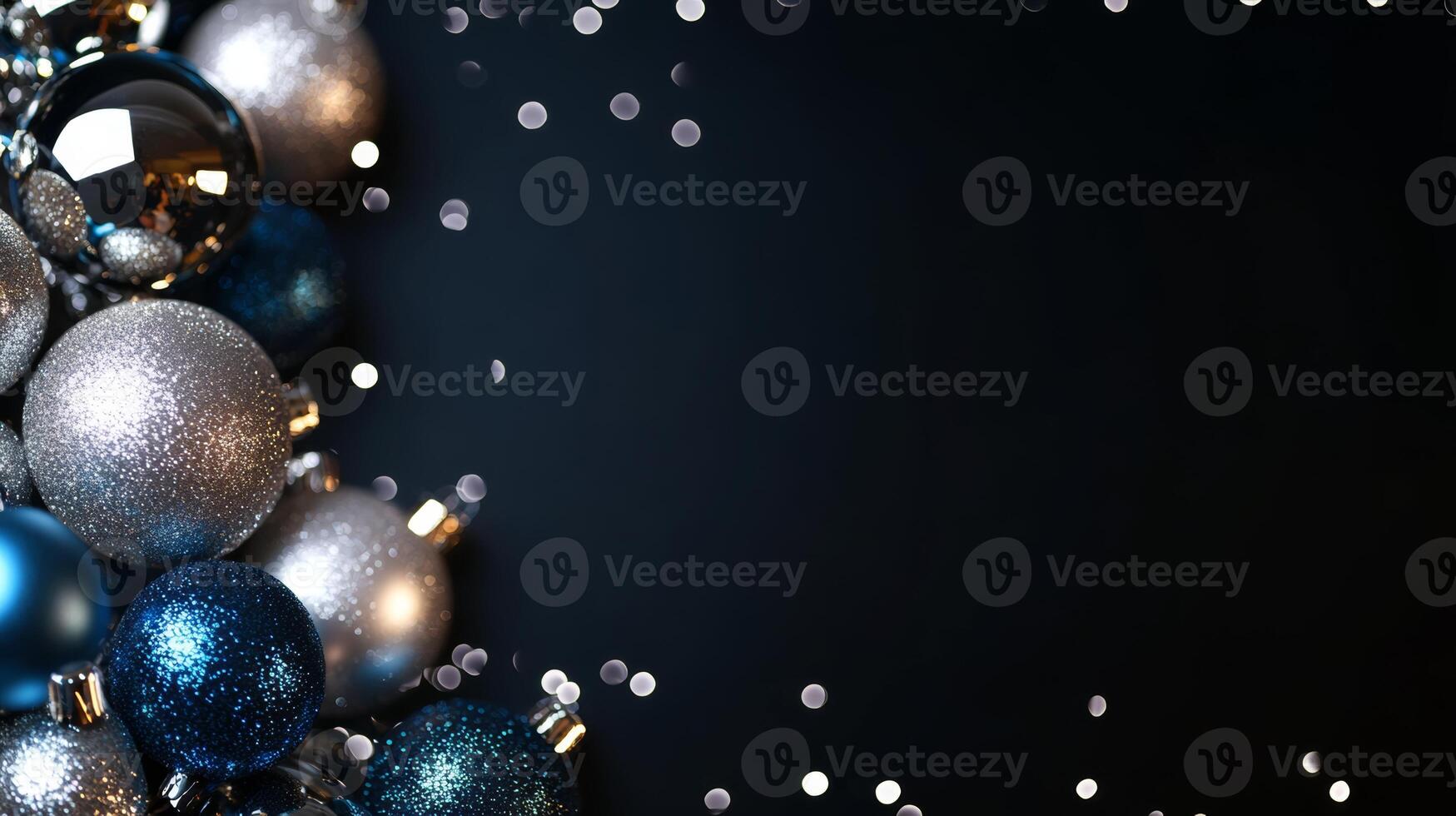 Shiny blue and silver Christmas ball ornaments on a black background with a blank space for custom text or designs photo