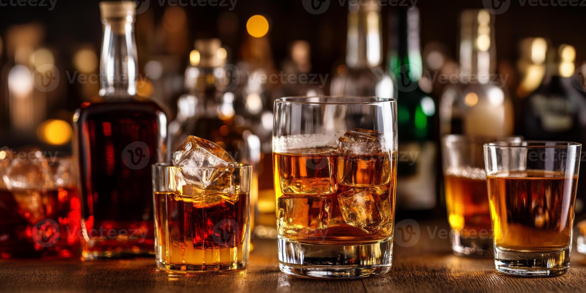 A variety of alcoholic drinks with ice displayed on a bar table, perfect for social gatherings and celebrations in an inviting atmosphere photo
