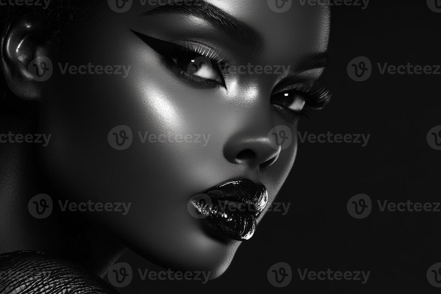 Striking portrait of a model with bold makeup and captivating gaze captured against a dark backdrop photo