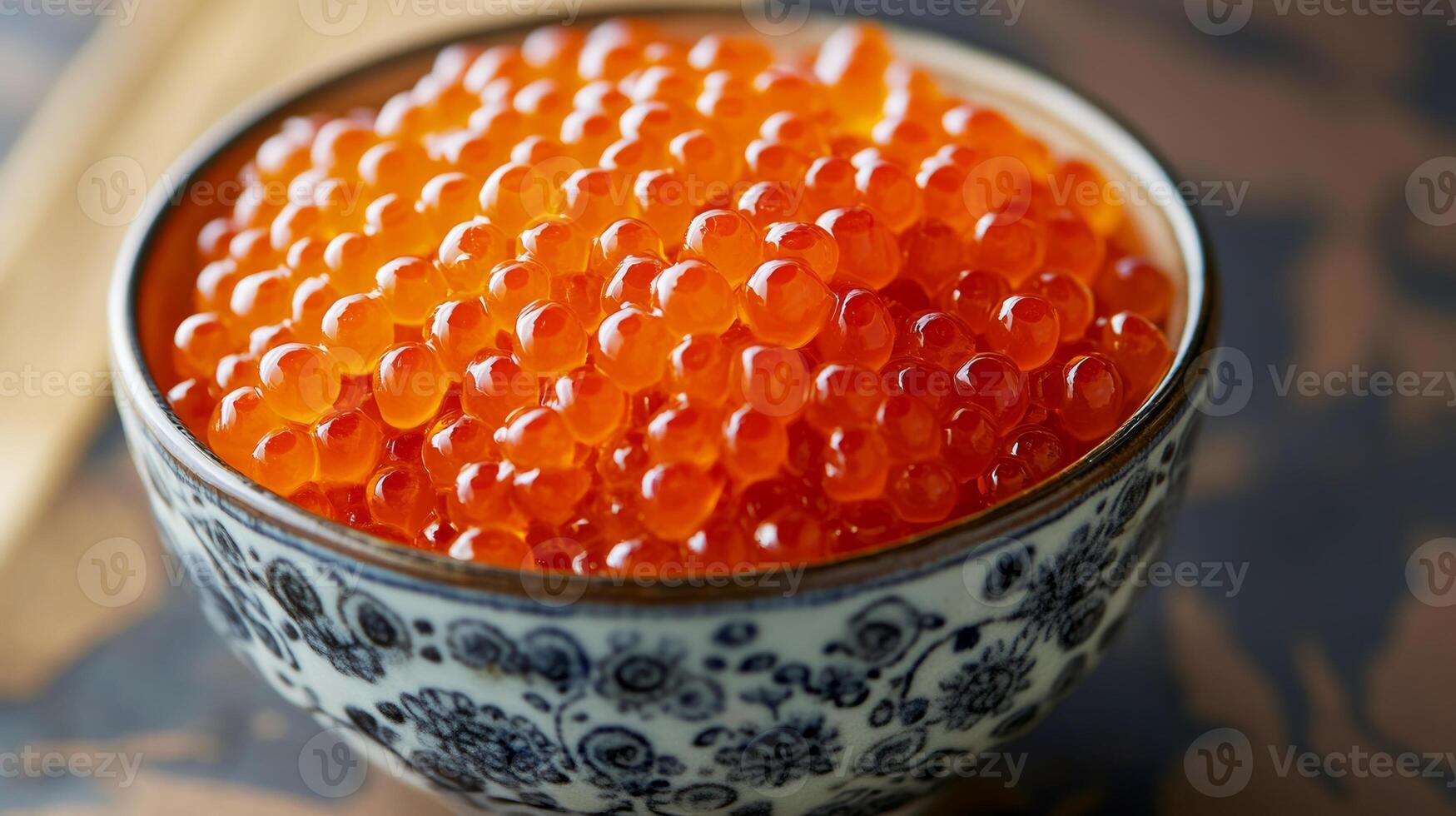Fresh salmon roe served in an elegant patterned bowl, showcasing its vibrant color and texture photo