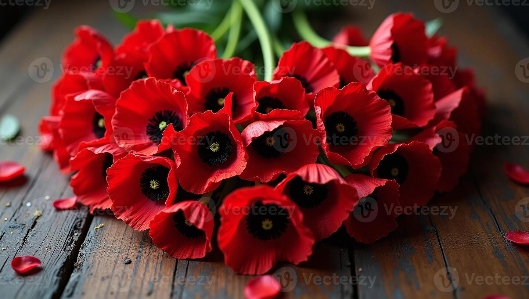Arrangement of Red Poppy Flowers on Rustic Wooden Surface with Fallen Petals photo