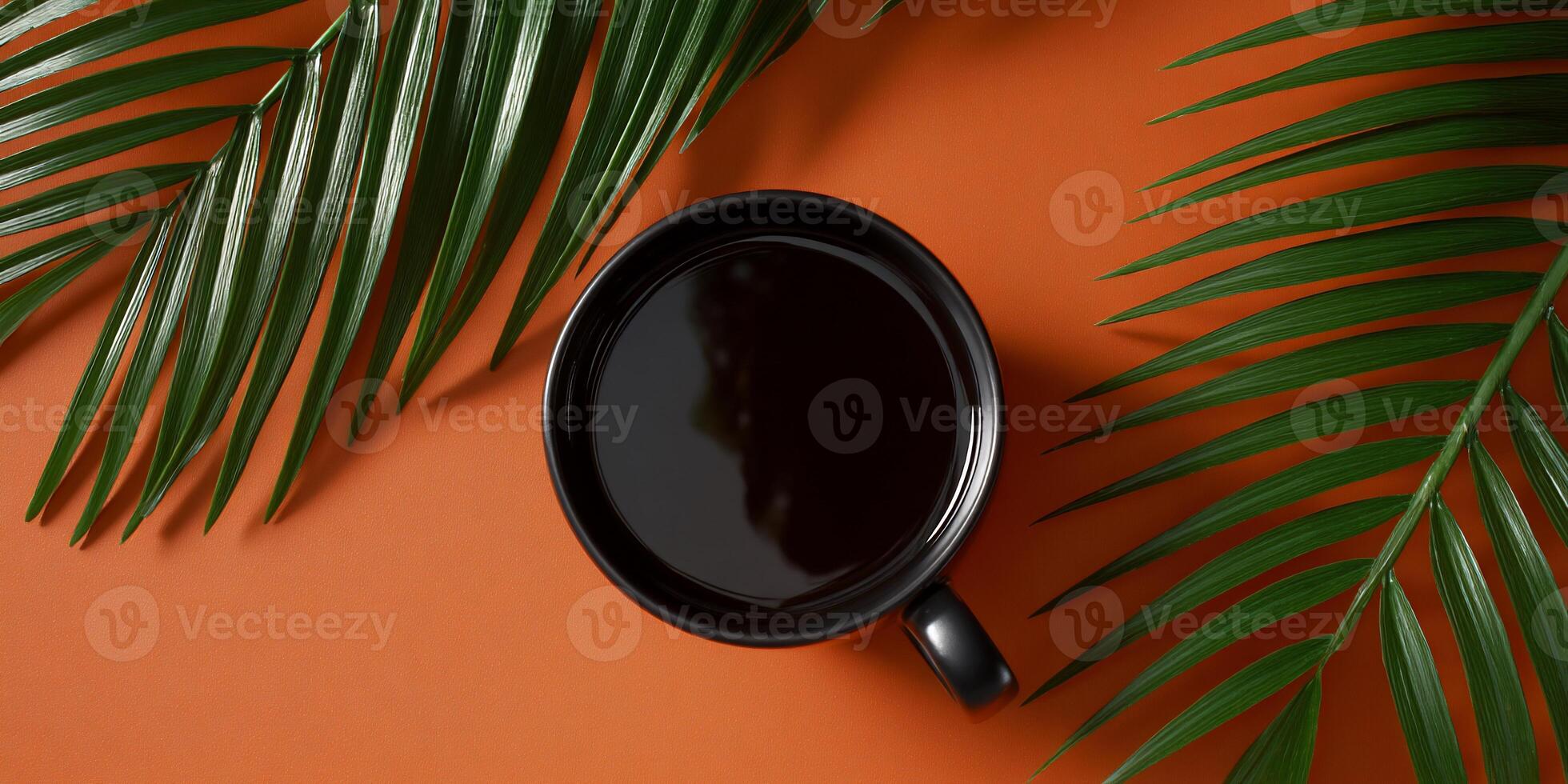Dark Coffee in a Mug, Surrounded by Palm Leaves photo