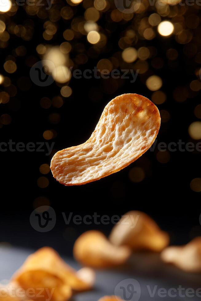 A piece of potato chips is floating in the air photo