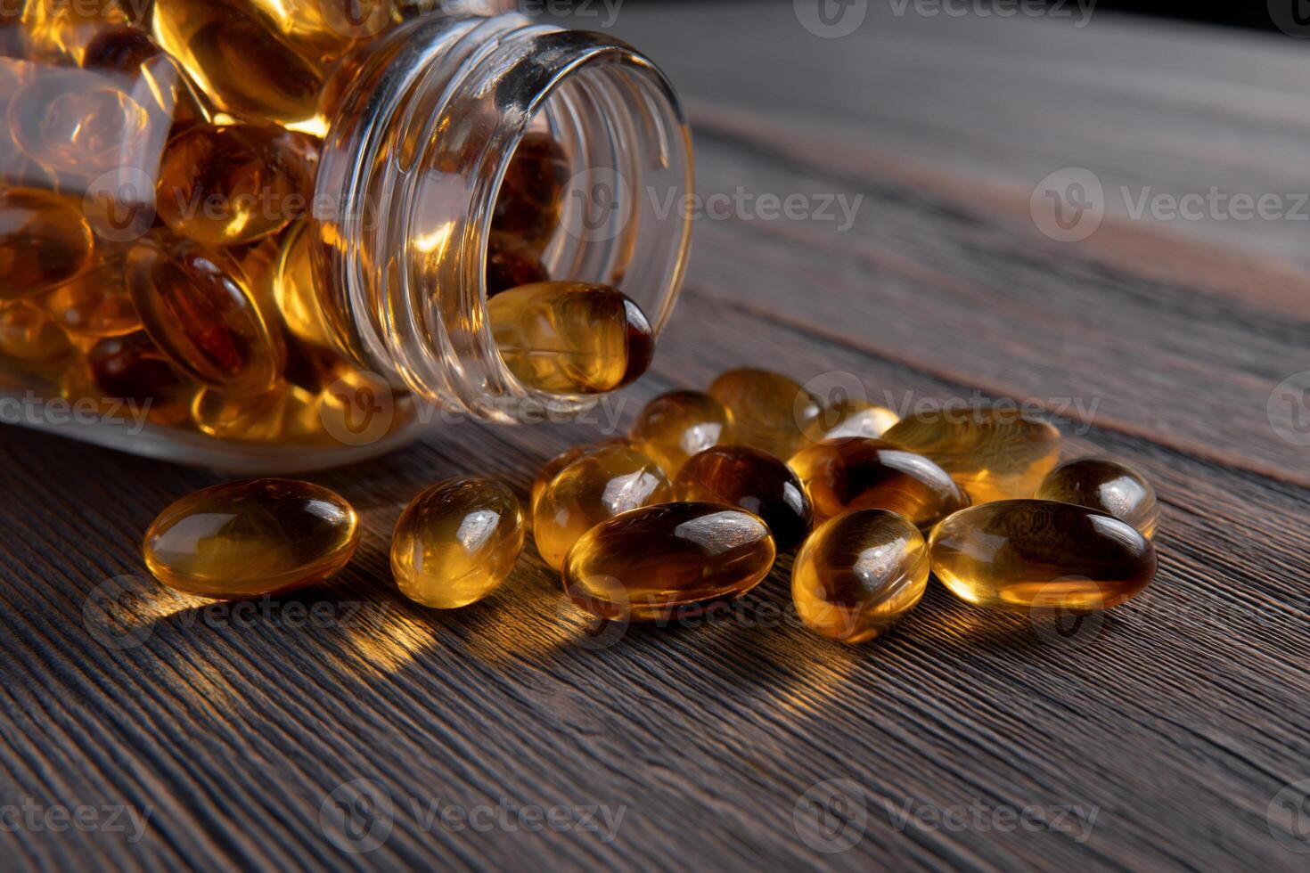 Amber capsules spilling from a jar photo