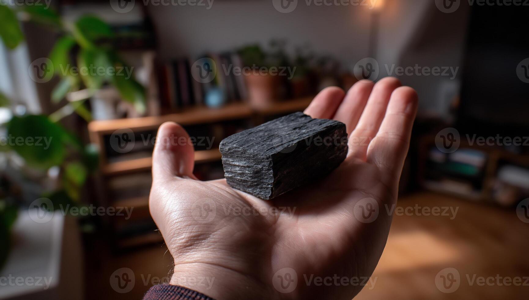 Dark stone held in hand photo