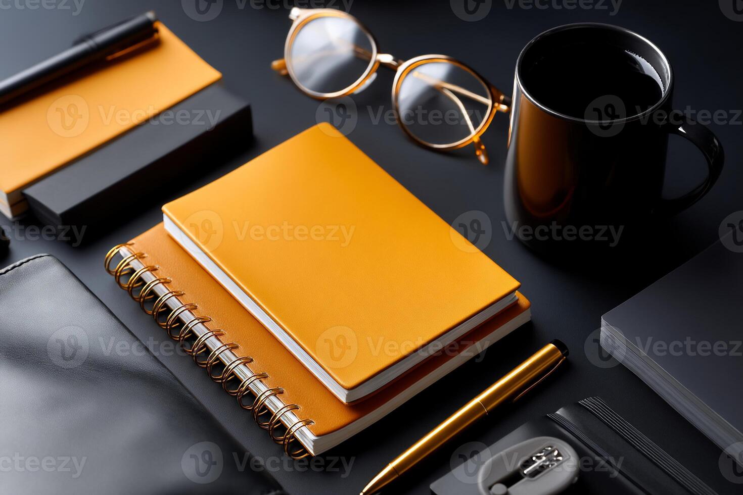 Organized workspace with orange and black stationery photo