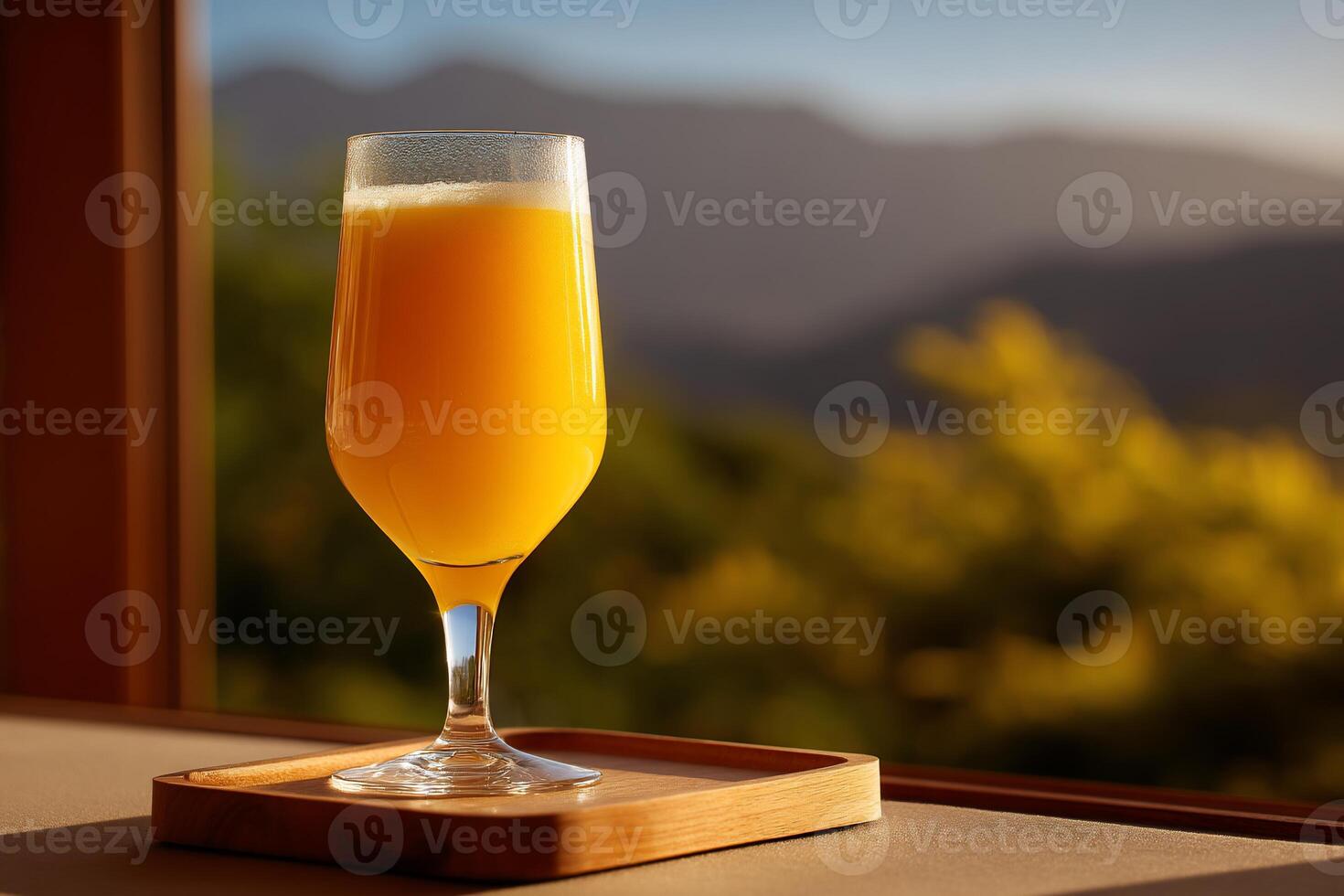 Orange juice in a glass by a window photo