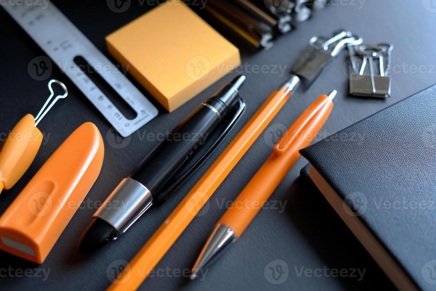 Assorted stationery items on a dark surface photo