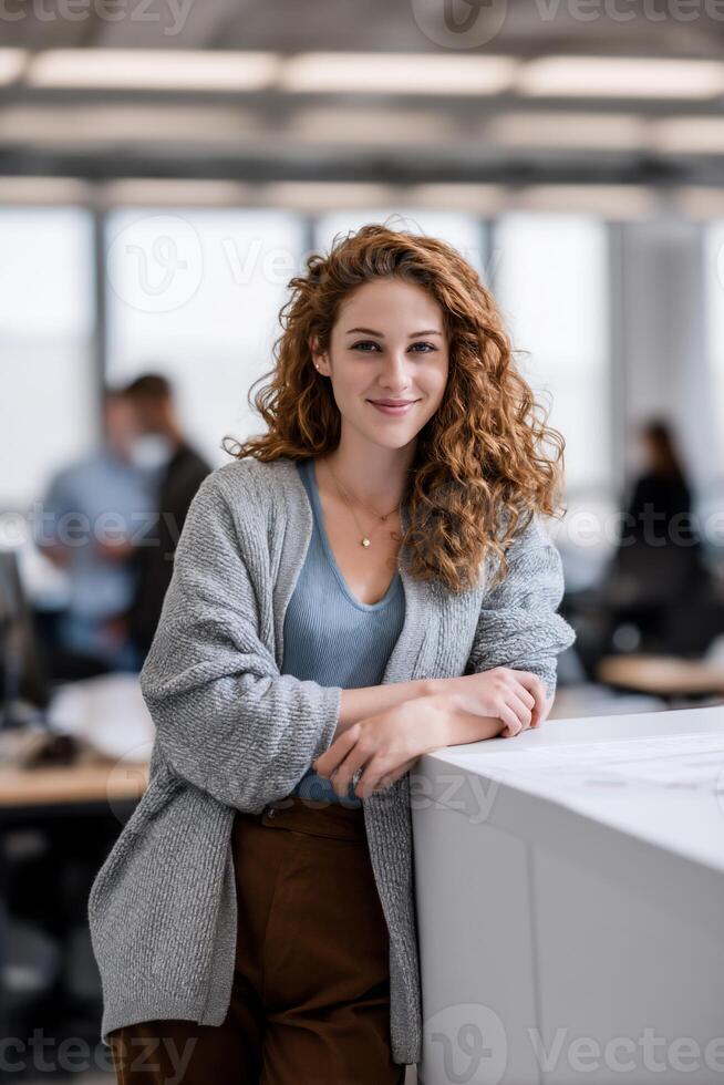 Young woman with curly hair, leaning on a light counter, smiling photo