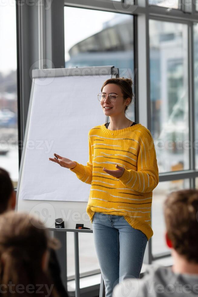 Woman giving presentation in front of whiteboard photo