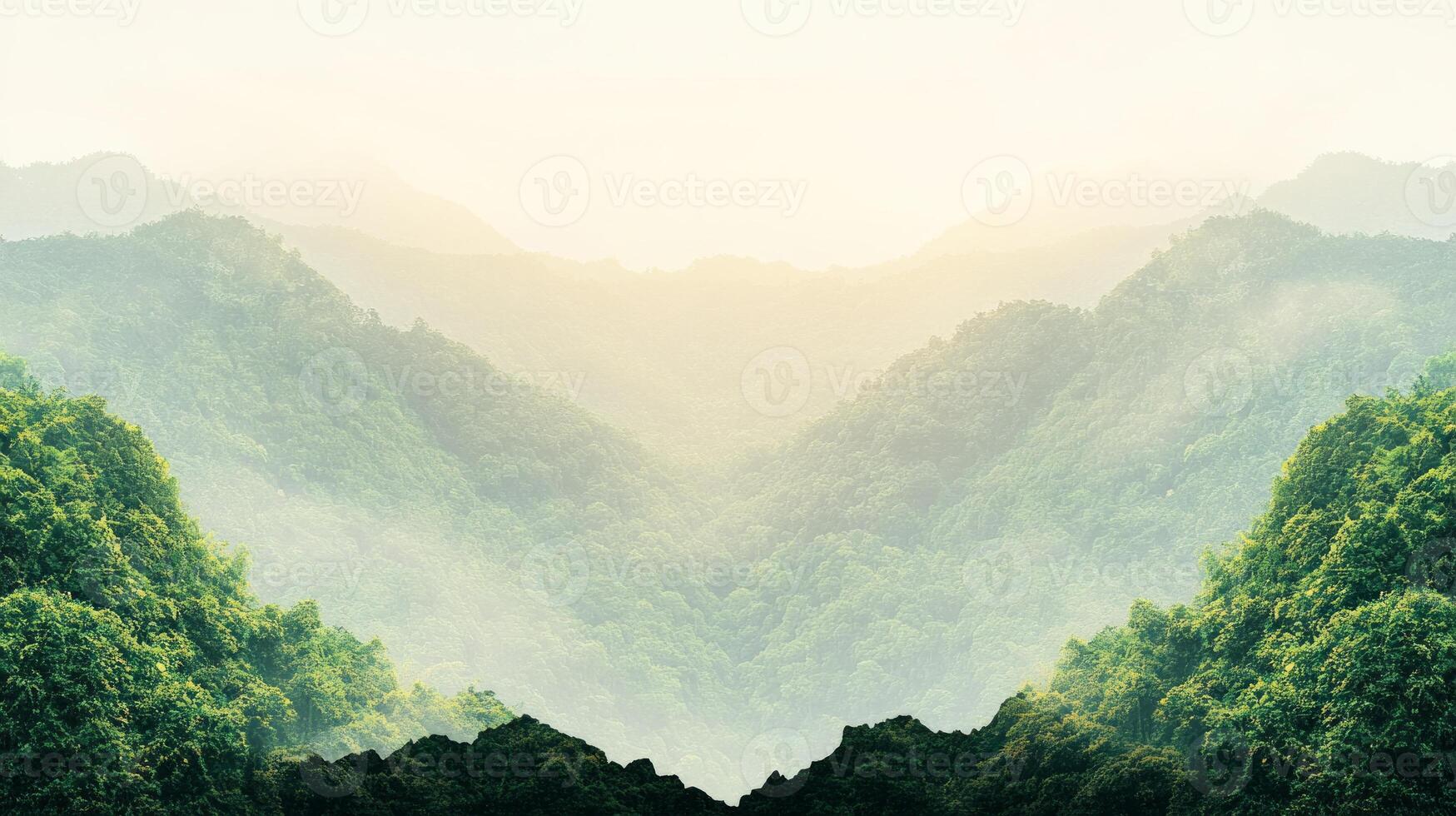 Misty mountains rise above dense tropical foliage as dawn breaks, creating a peaceful atmosphere in this untouched jungle landscape photo