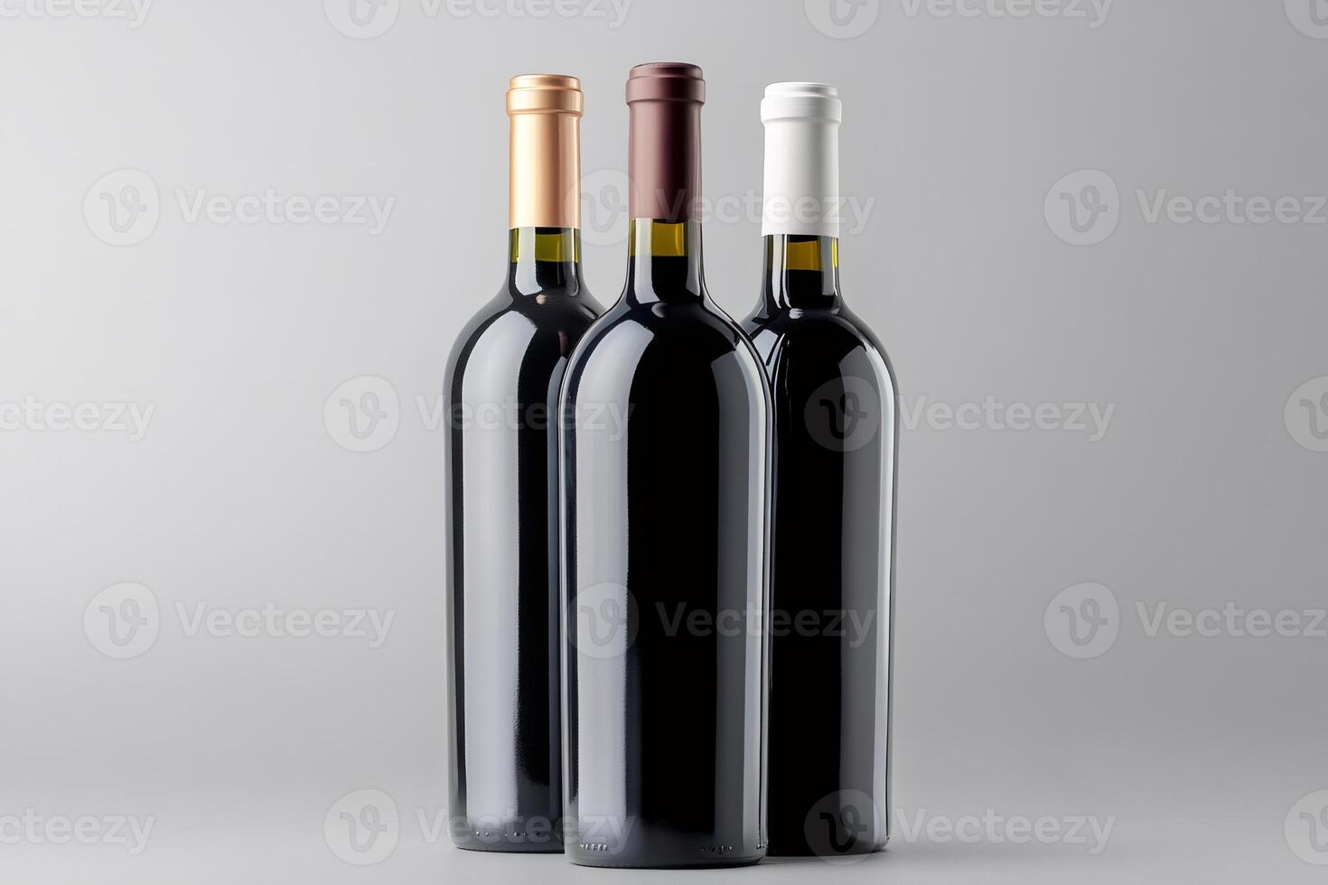 Three wine bottles with different colored capsules are standing on gray background photo