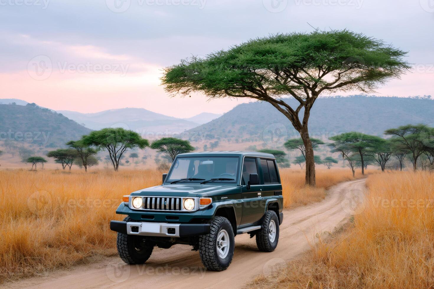 Toyota Land Cruiser driving on a dirt road at sunset in the african savanna photo