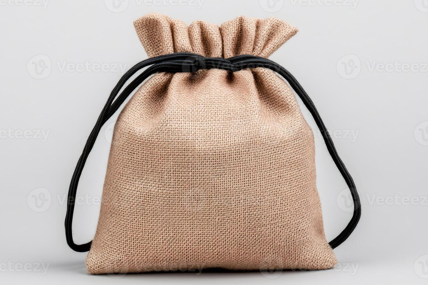 Small hessian sack with black string standing on white background photo