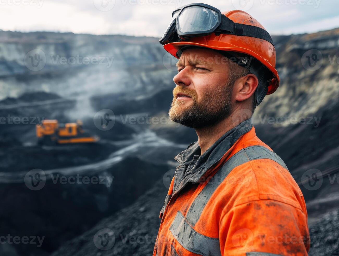 Workers assess mining operations in an open pit extraction site photo