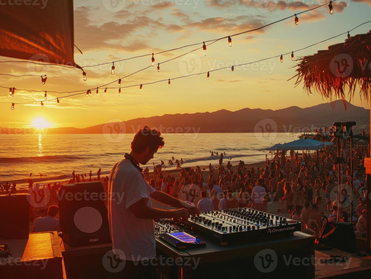 Sunset DJ performance on a beach during a vibrant summer evening photo
