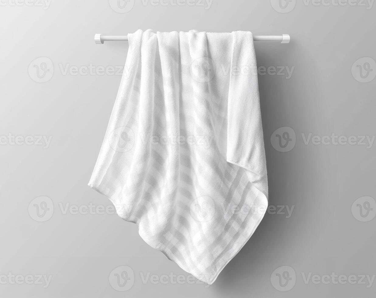 Soft white towel hung neatly on a minimalistic rack photo