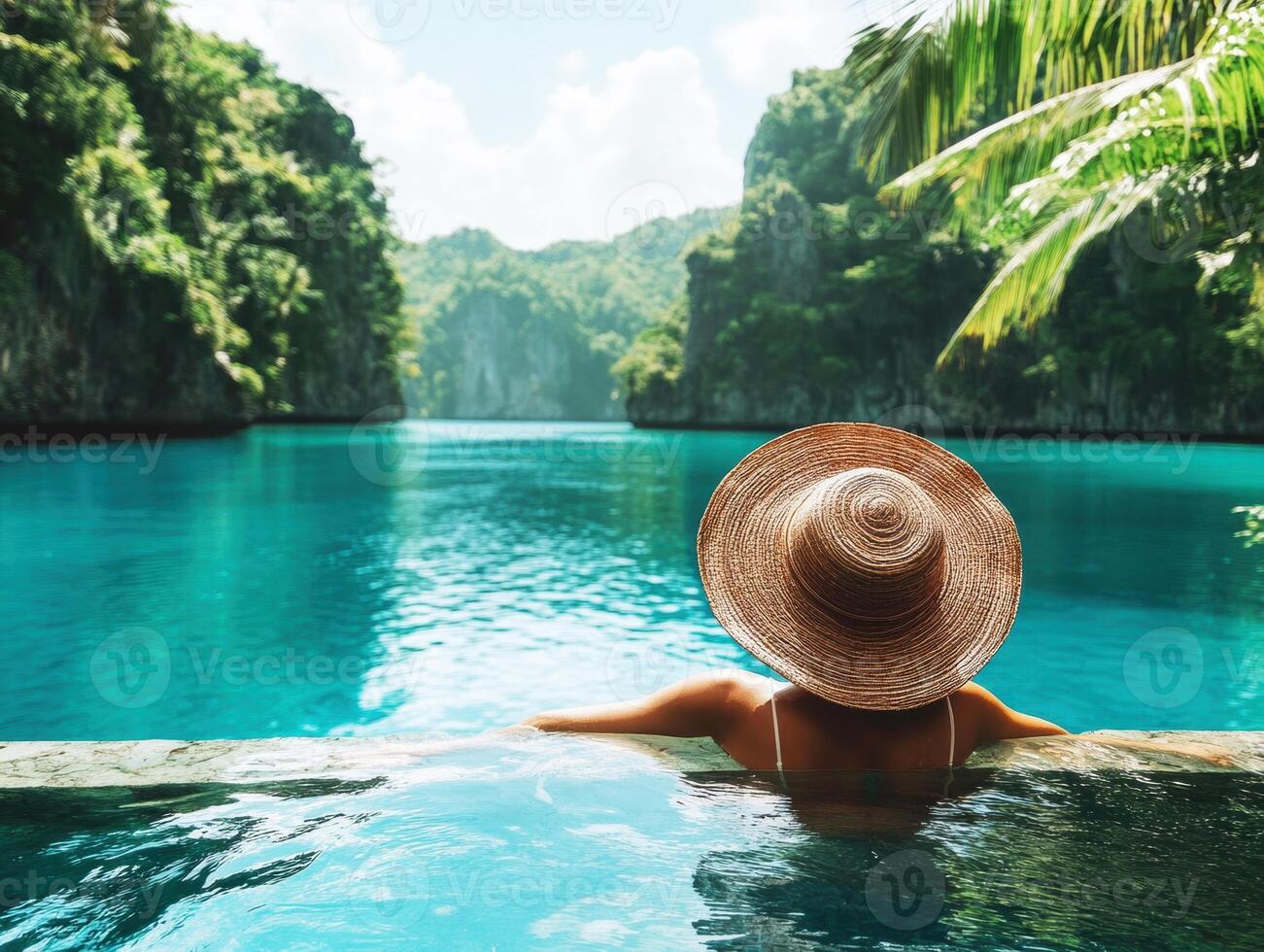 Relaxing by the turquoise lagoon with lush mountains surrounding photo