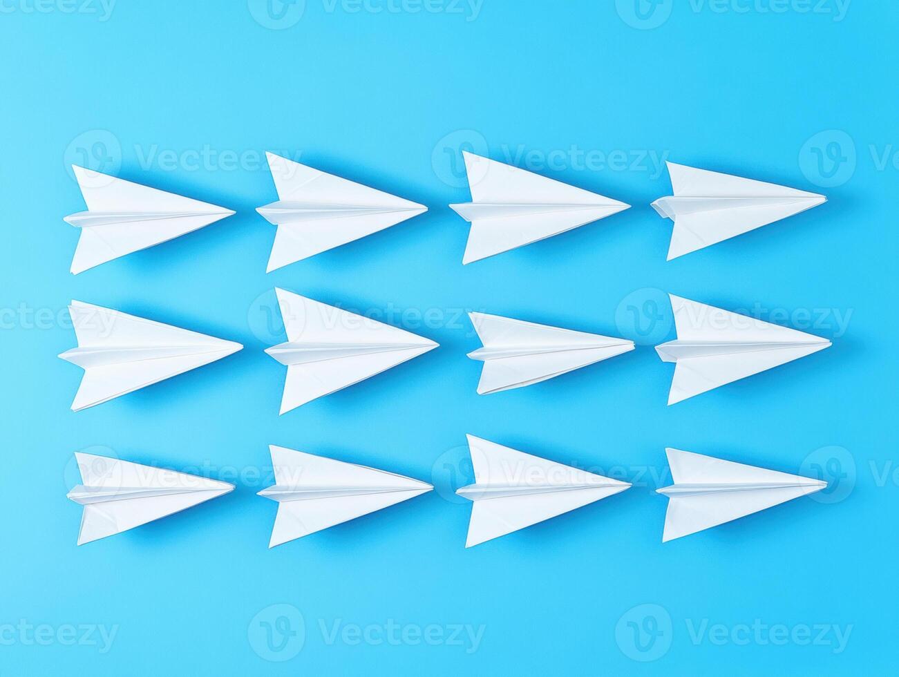 Ten paper airplanes arranged on a blue background for fun exploration photo
