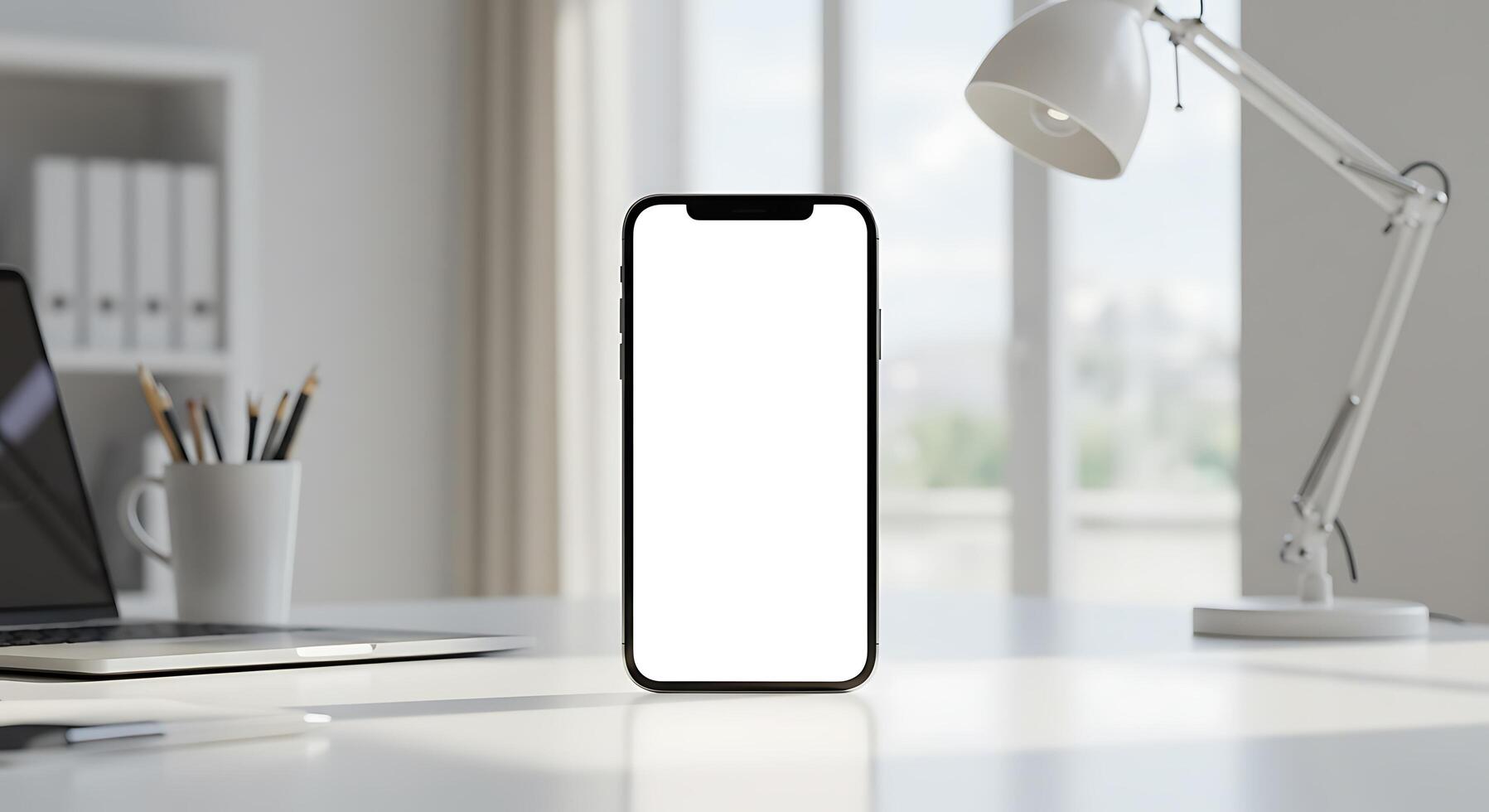 Mockup of an iphone on a desk with a laptop and a lamp photo