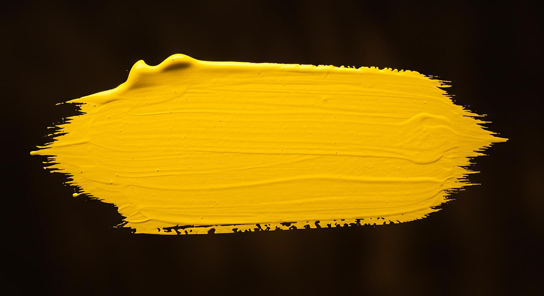 Yellow paint on a black background photo