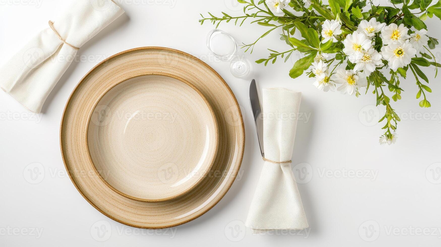 A stylish table setting features a beige dinner plate and bowl with linen napkins flowers and silverware on a white background perfect for sp or summer gathes. photo