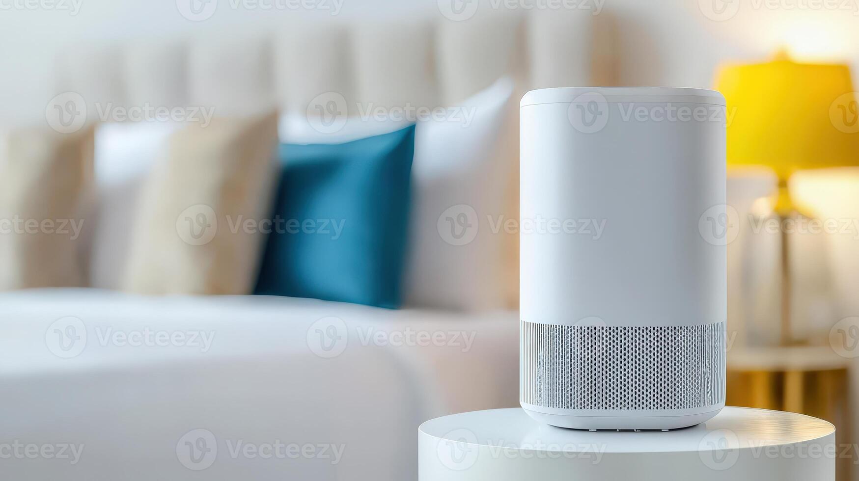 A smart speaker is sitting on a table in front of a bed photo