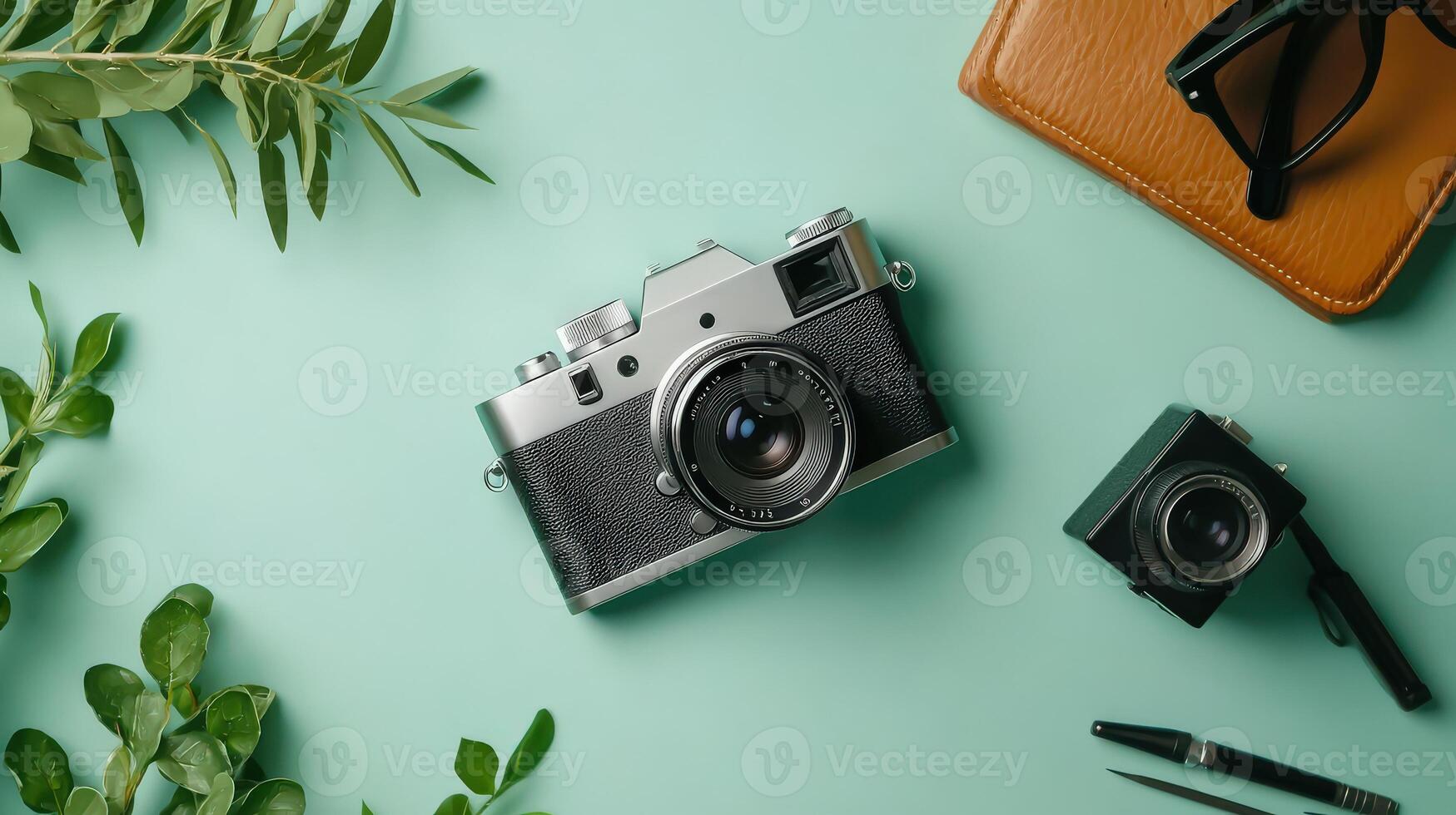 A vintage camera, a wallet, a pair of sunglasses, and a pair of sunglasses on a photo