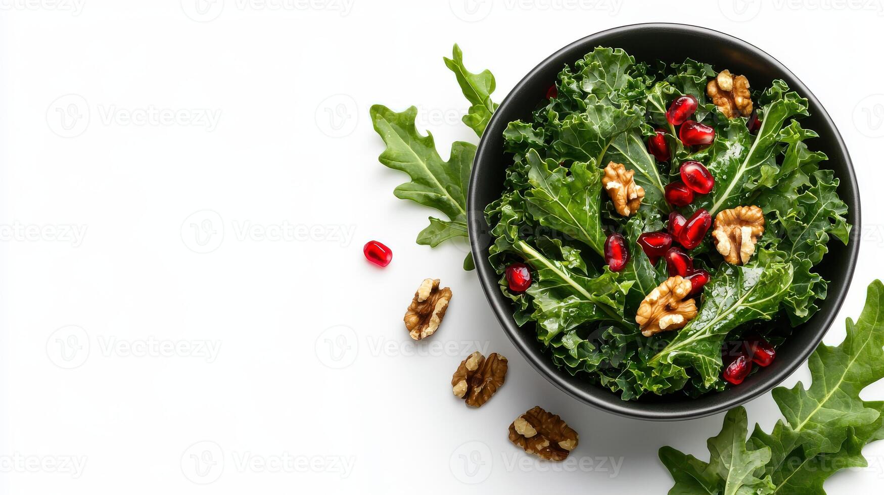 A bowl of kale salad with walnuts and pomegranate photo