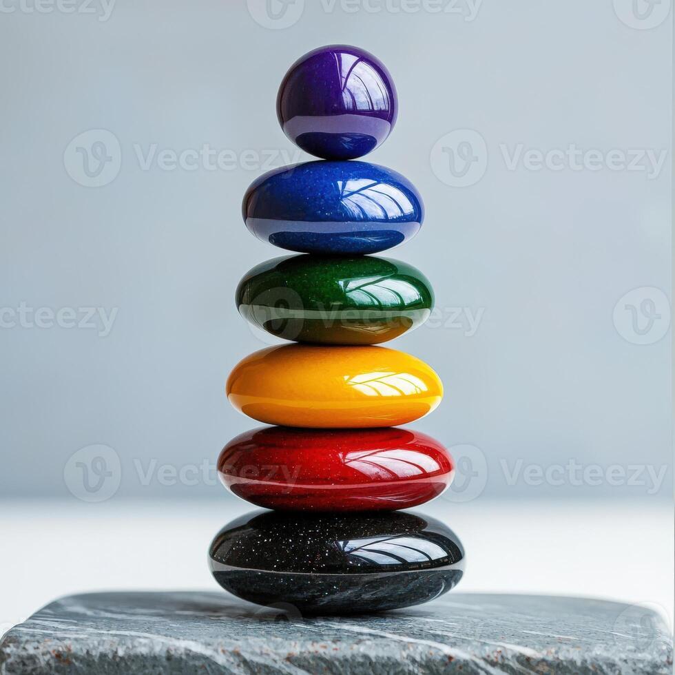 A stack of colorful stones on top of a stone slab photo
