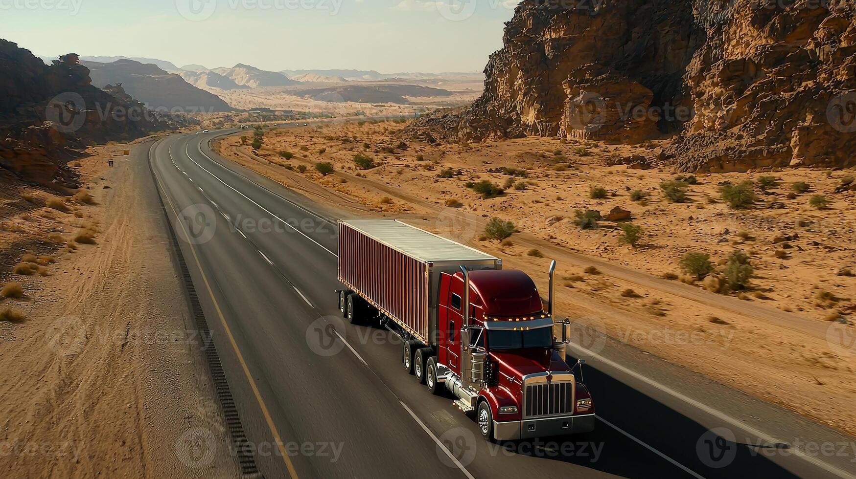 A red semi truck driving down a desert road photo
