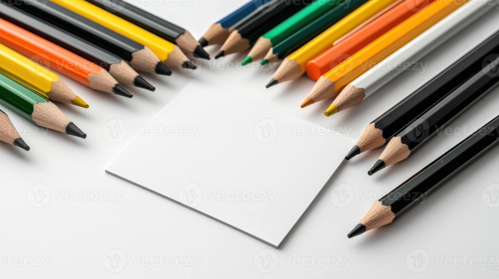 A group of colored pencils and a blank piece of paper photo