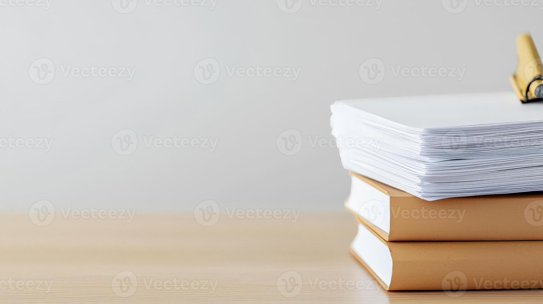 Stack of books and pen on wooden table photo