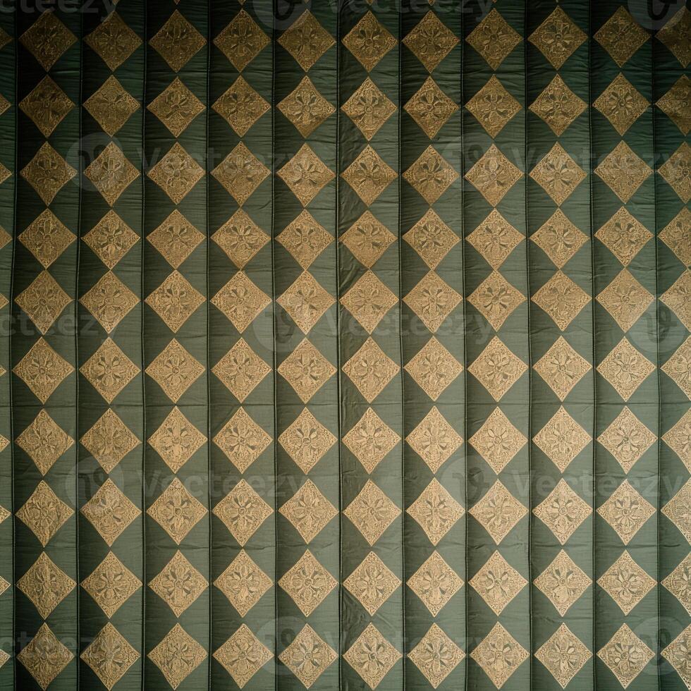 A green and gold checkered wall with a diamond pattern photo