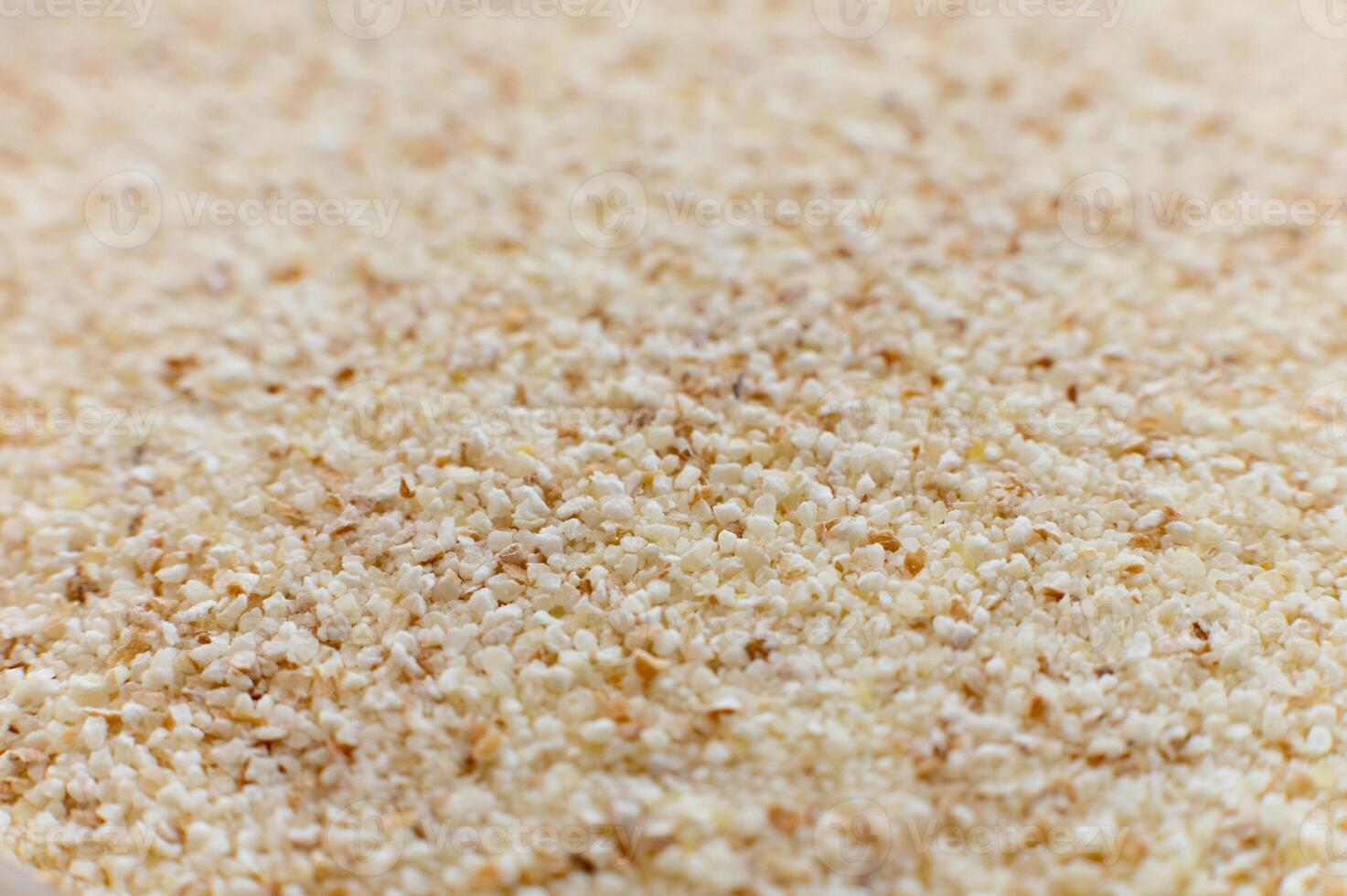 Close-up of raw semolina background in macro mode and soft focus photo