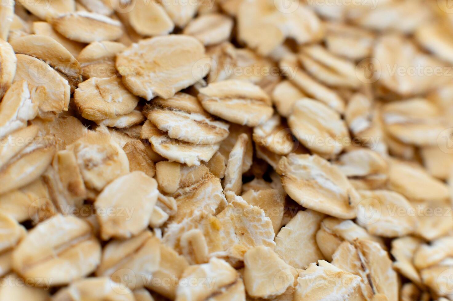Close-up macro shot of raw oat flakes in shallow depth of field photo