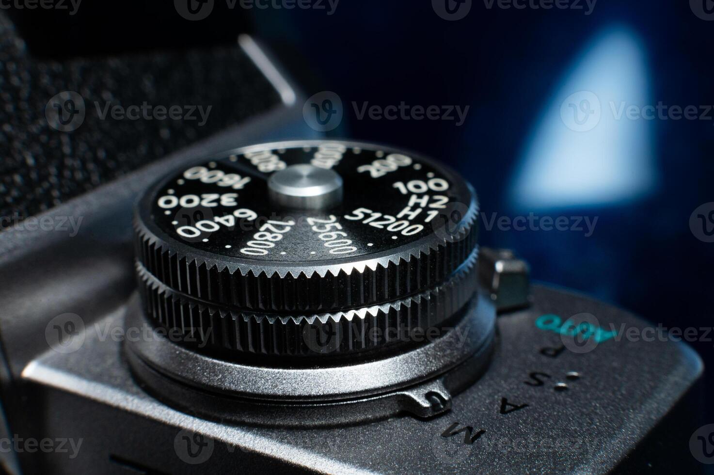 Shutter button on a retro film camera close-up. Modern digital camera made in retro style, close-up of the button that adjusts the shutter speed photo