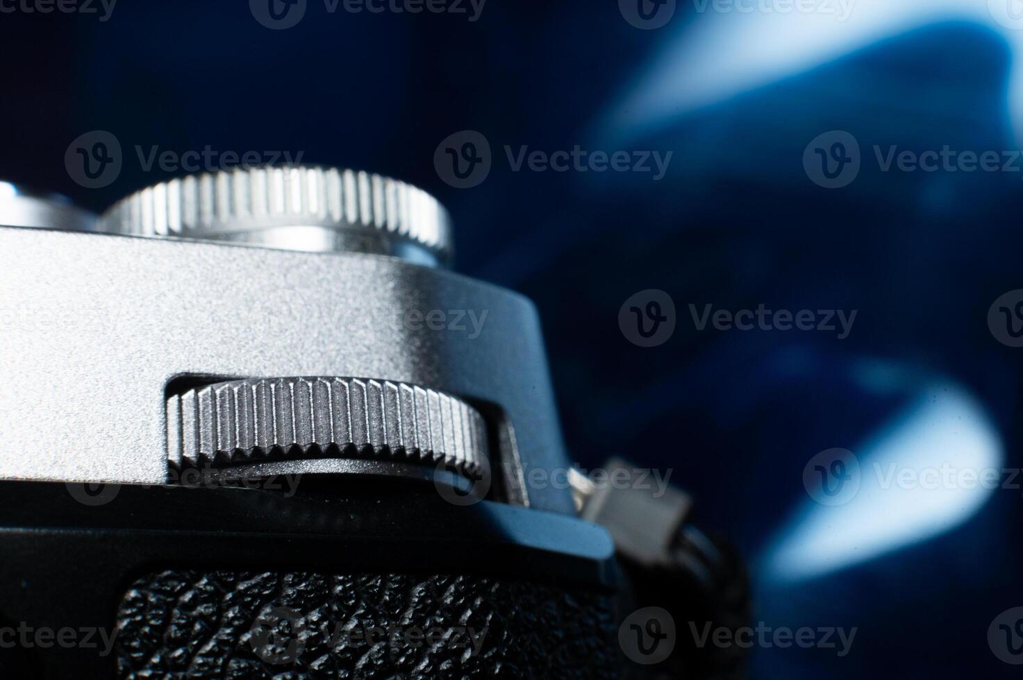 Close-up macro shot of retro style camera controls. Silver camera controls in soft focus photo