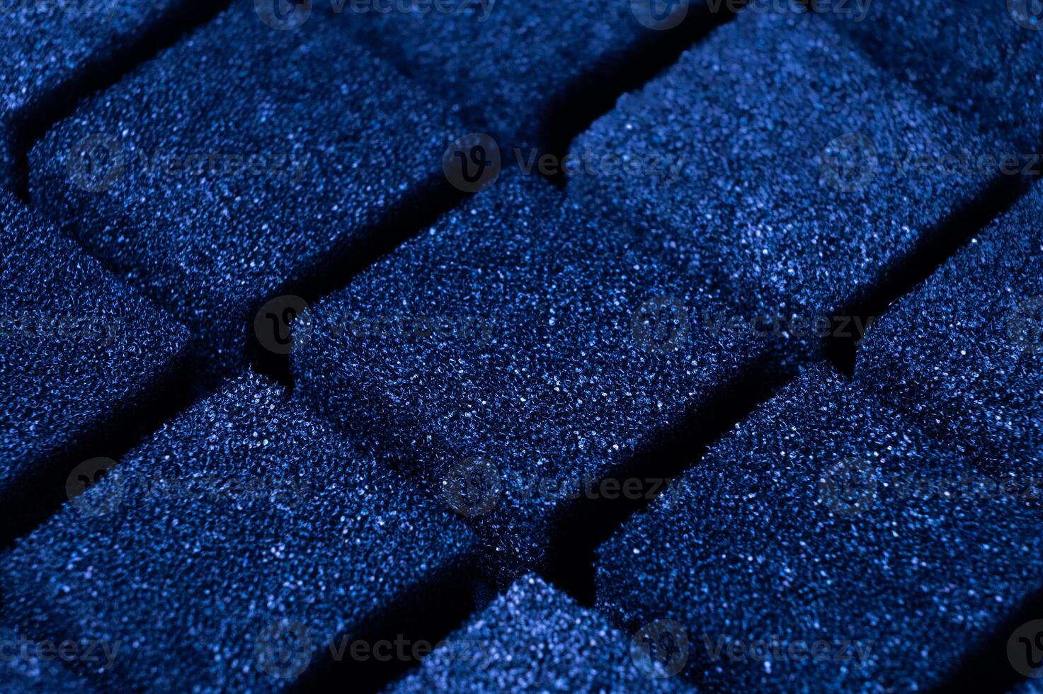 Blue Cubes of flexible foam sponges laid out in a pattern. Macro close-up in soft focus. Abstract cubic background photo