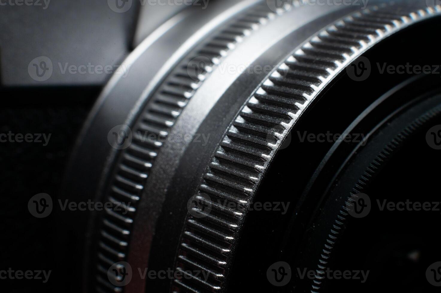 Macro photography of camera parts, featuring symmetry, texture and precision. Close-up of lens rings, ribbed surface photo